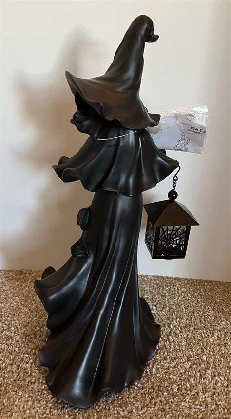 Voodoo witch with illuminated lantern cracker barrel
